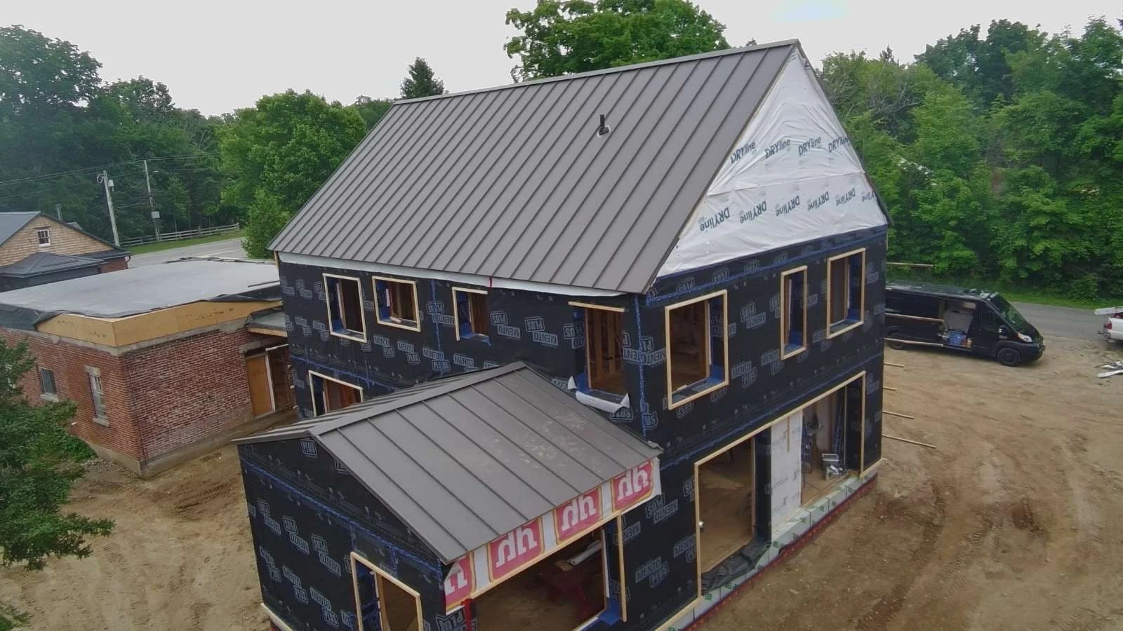 Standing seam roof on a two-storey home during construction
