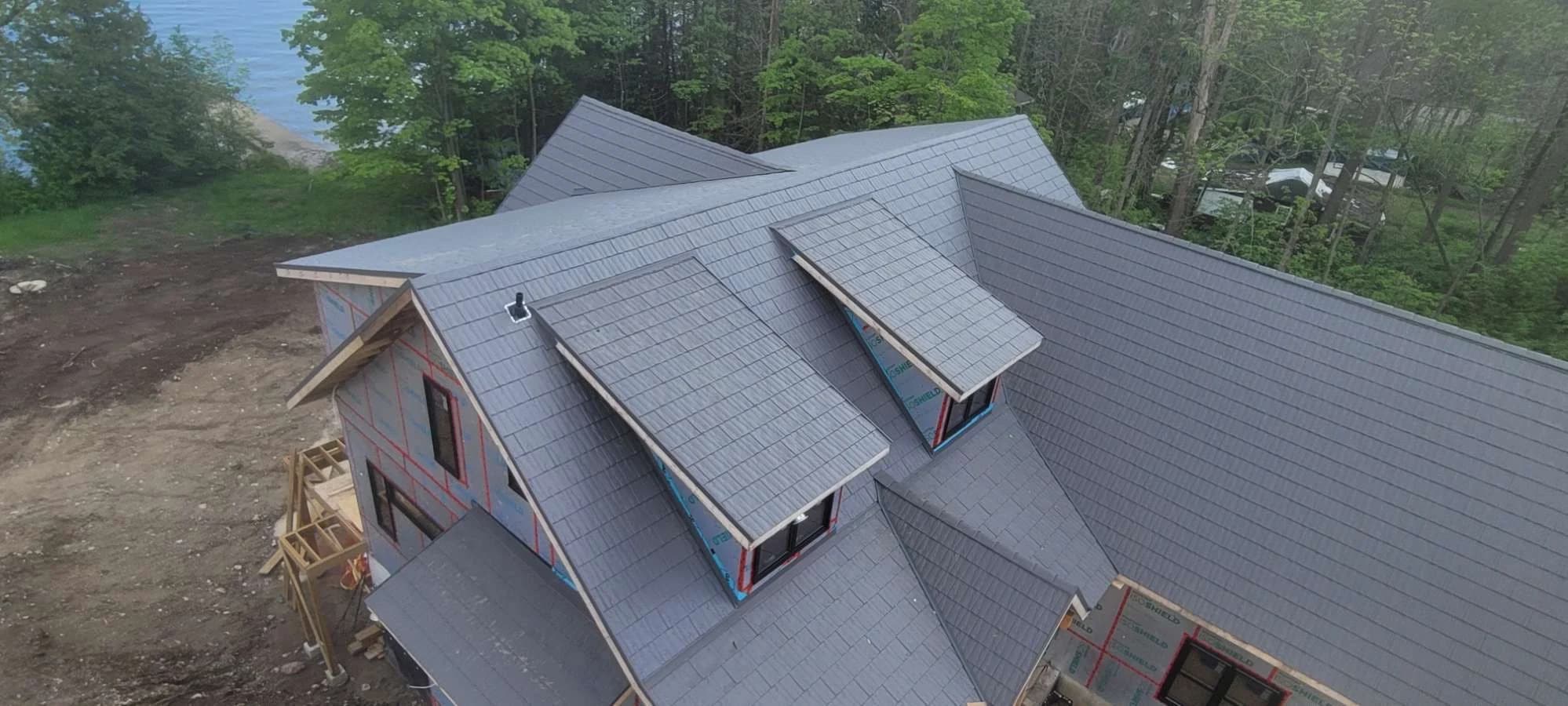 Metal shingle roof with intersecting gables and dormers