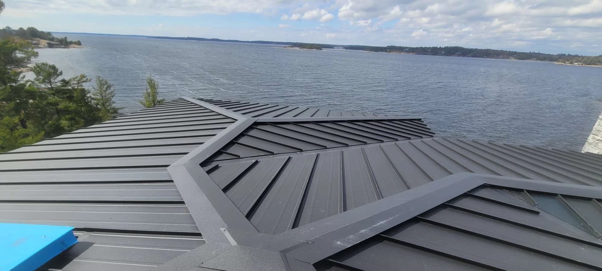 Standing seam roof intersections overlooking open water