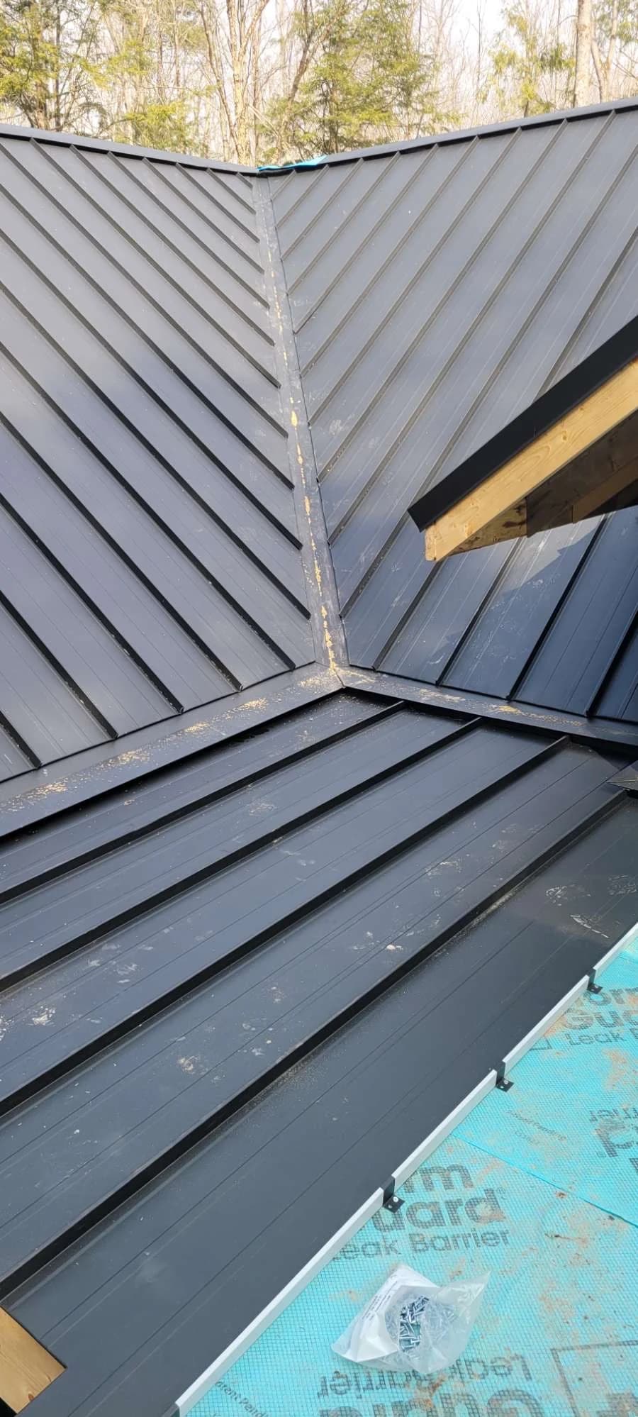 Close view of standing seam roof intersections during installation