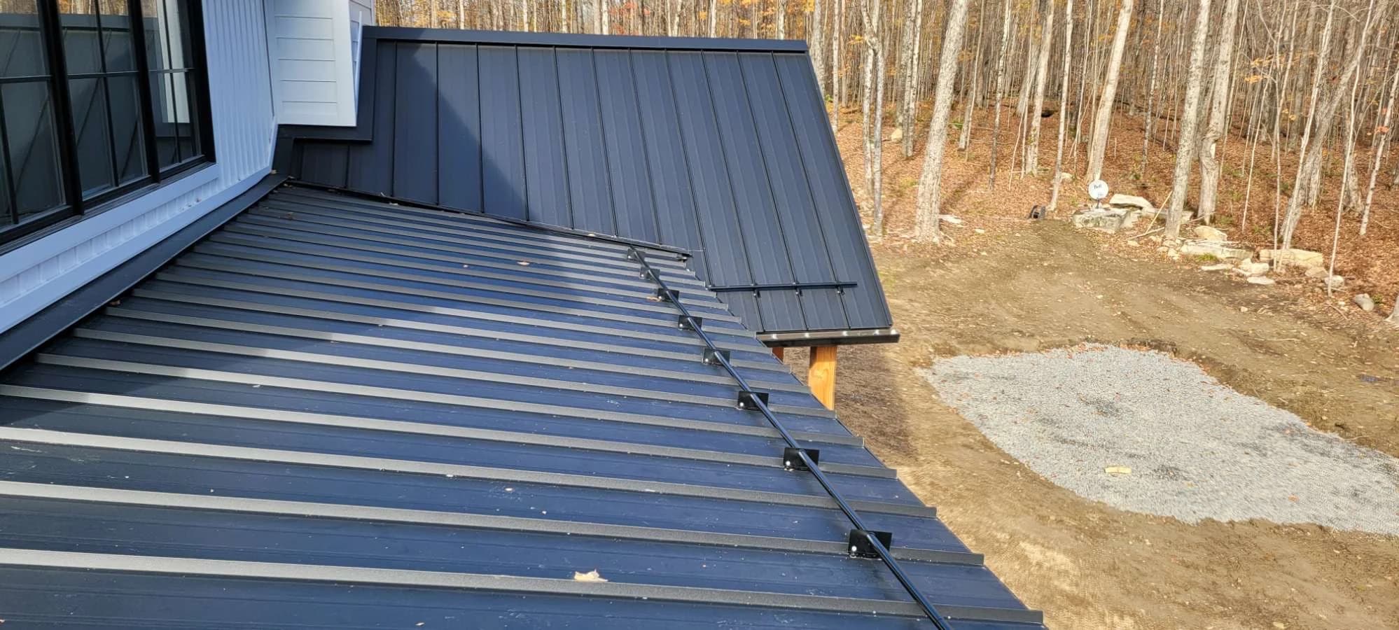 Metal roof and snow retention below an upper wall