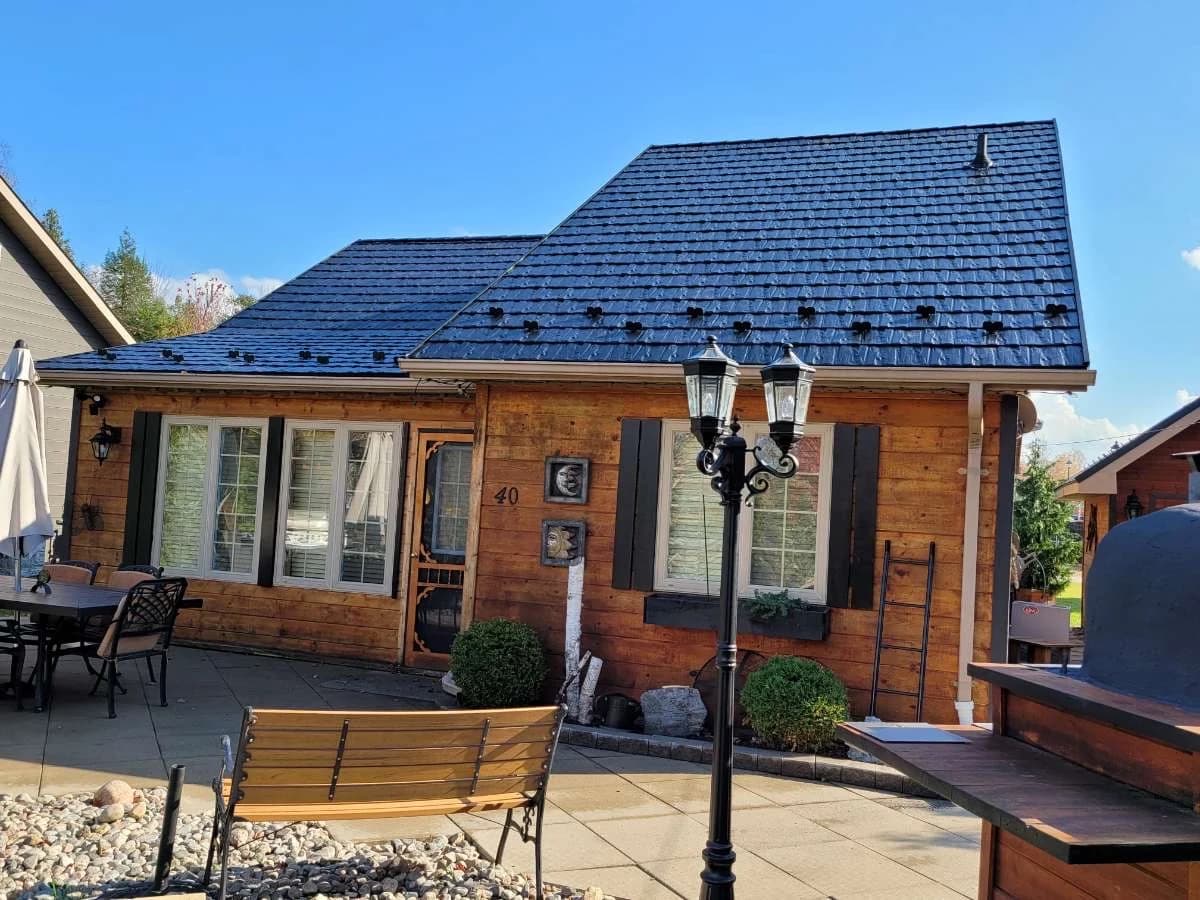 Metal shingle roof on a brick home with a patio