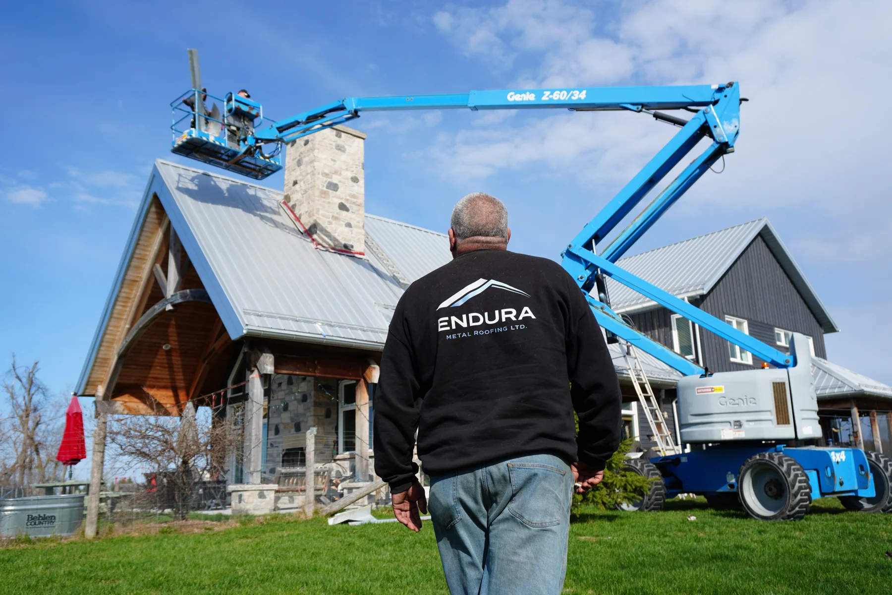 Ken, seen from behind in his Endura jacket, looking up at the roof on site